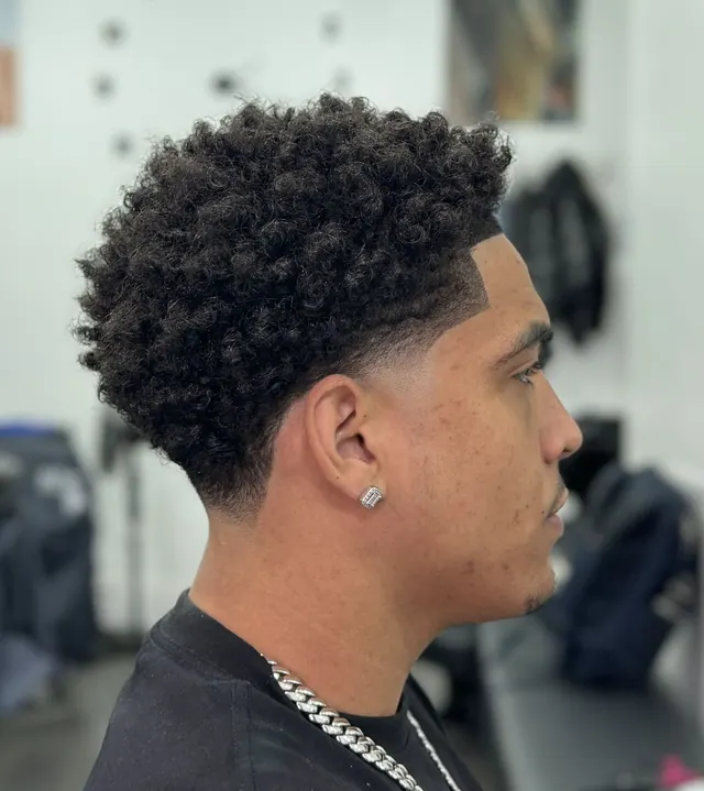 Curls on top with a low taper