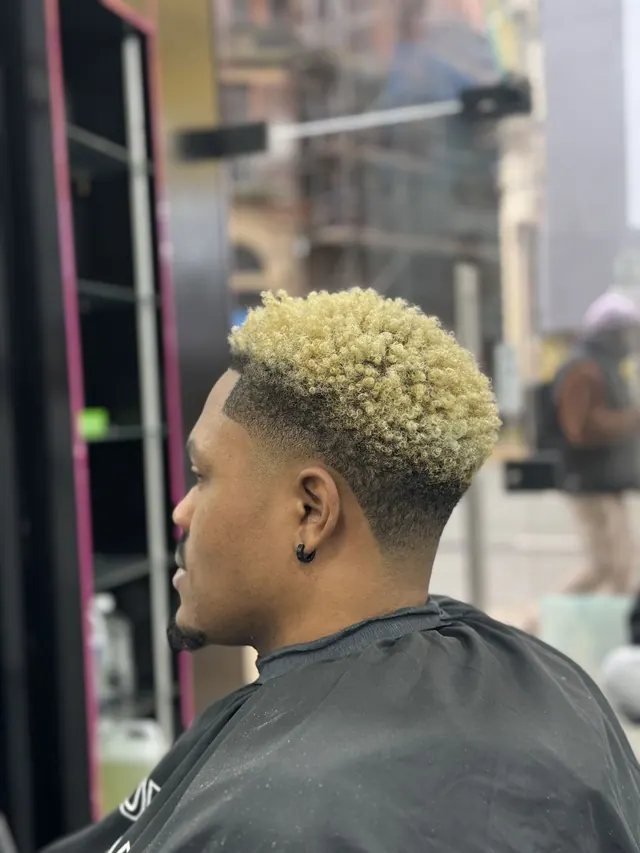 A bleached curly top with a fade